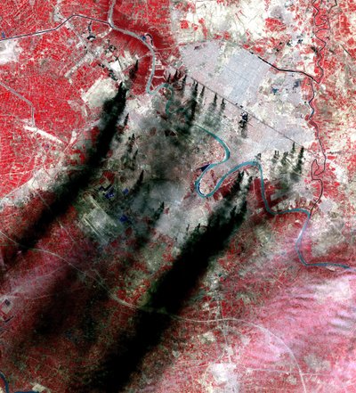 Smoke plumes above Baghdad, Iraq, originating along major roads and canals, believed to be burning pools of oil from pipelines. Taken by NASA during the 2003 Invasion of Iraq by National Aeronautics and Space Administration National Aeronautics and Space Administration